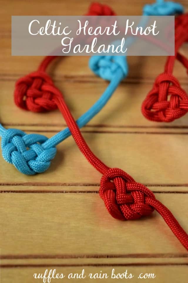 close up of teal and red celtic heart knot garland on wood background
