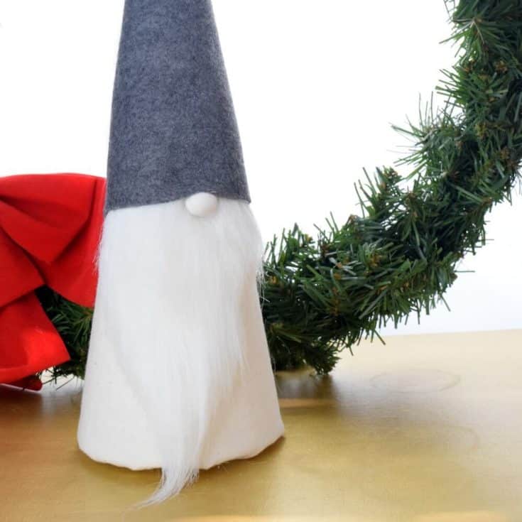 Make this easy DIY Christmas gnome for holiday decor. It has a cute button nose and fits in with any decorating style! #DIYcrafts #DIYholiday #handmadeholiday #Christmascrafts #minimalism