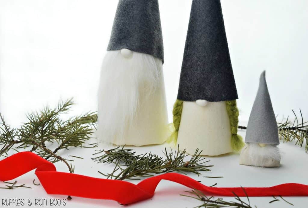 Christmas Tomte Nisse made from cones and felt on a holiday, Scandinavian background.