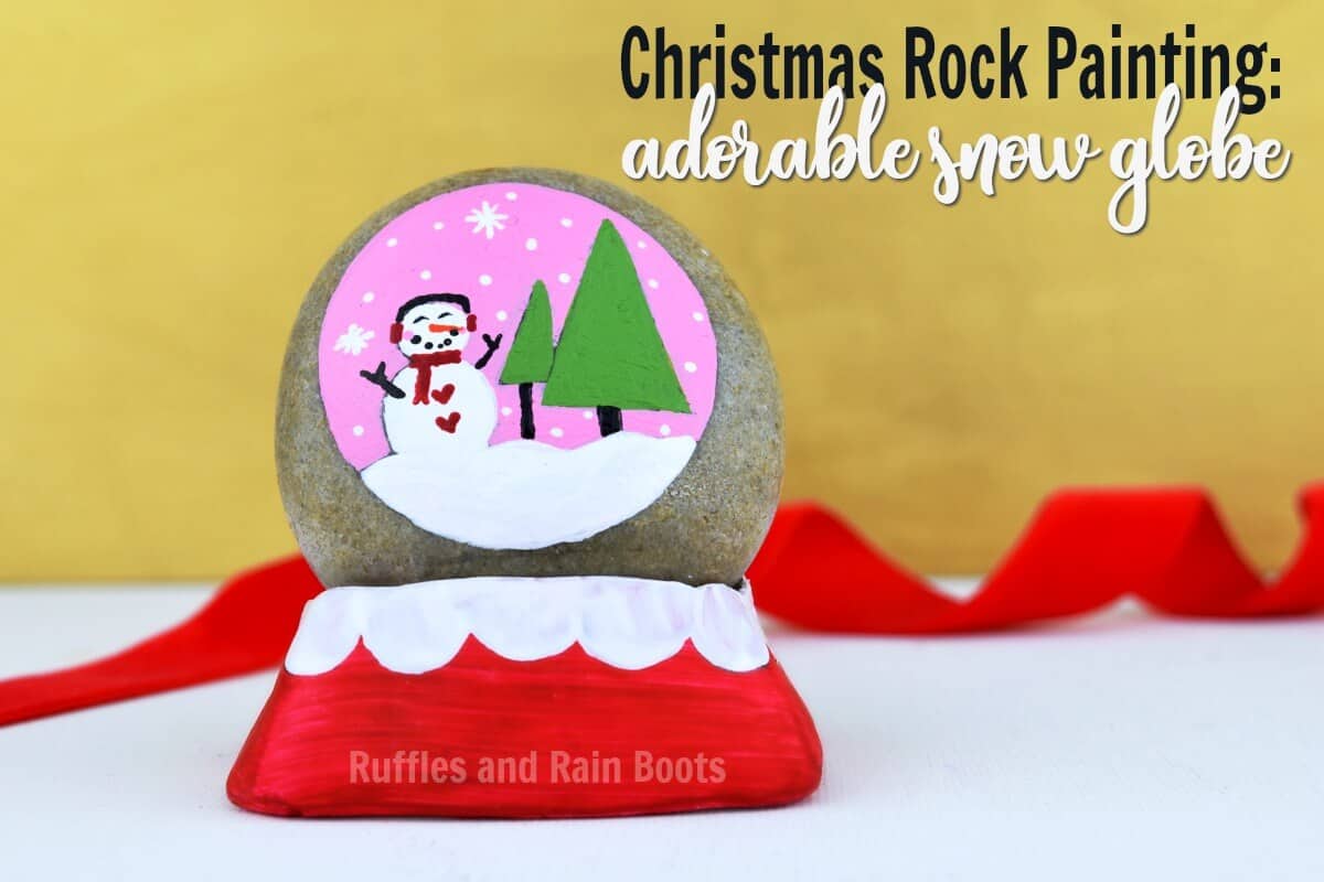 snow globe rock painting with polymer clay stand