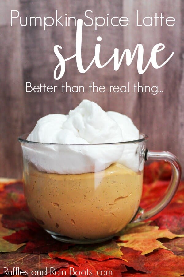 orange slime with white foamy slime on top in a clear glass cup with text that reads pumpkin spice slime