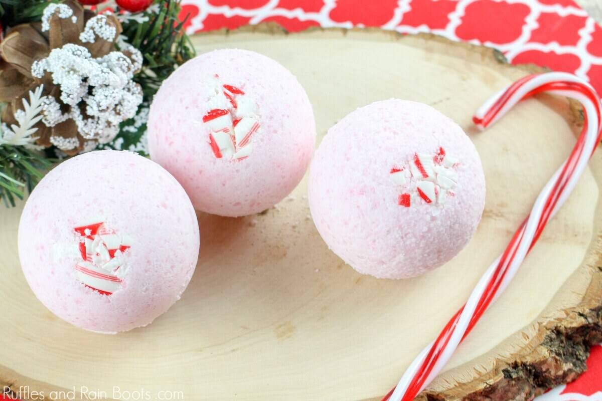 An easy Christmas DIY gift idea - candy cane bath bomb recipe with peppermints on a wood background