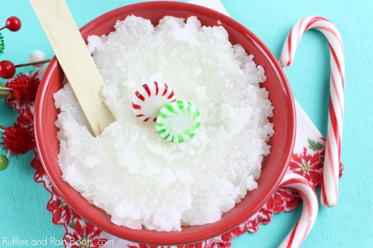 overhead photo of a white Christmas body scrub in a red bowl with candy canes