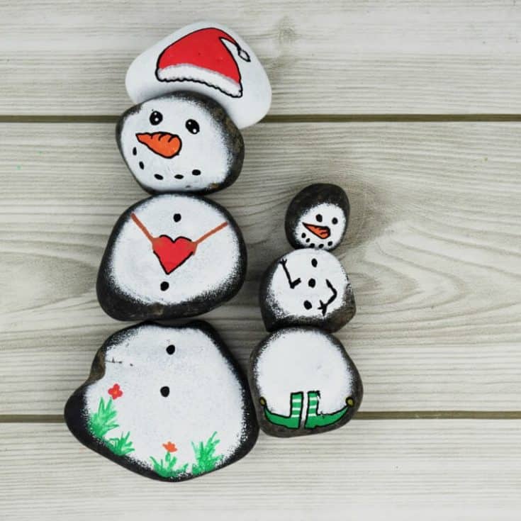 Snowman Story Stones Rock Painting on wood background