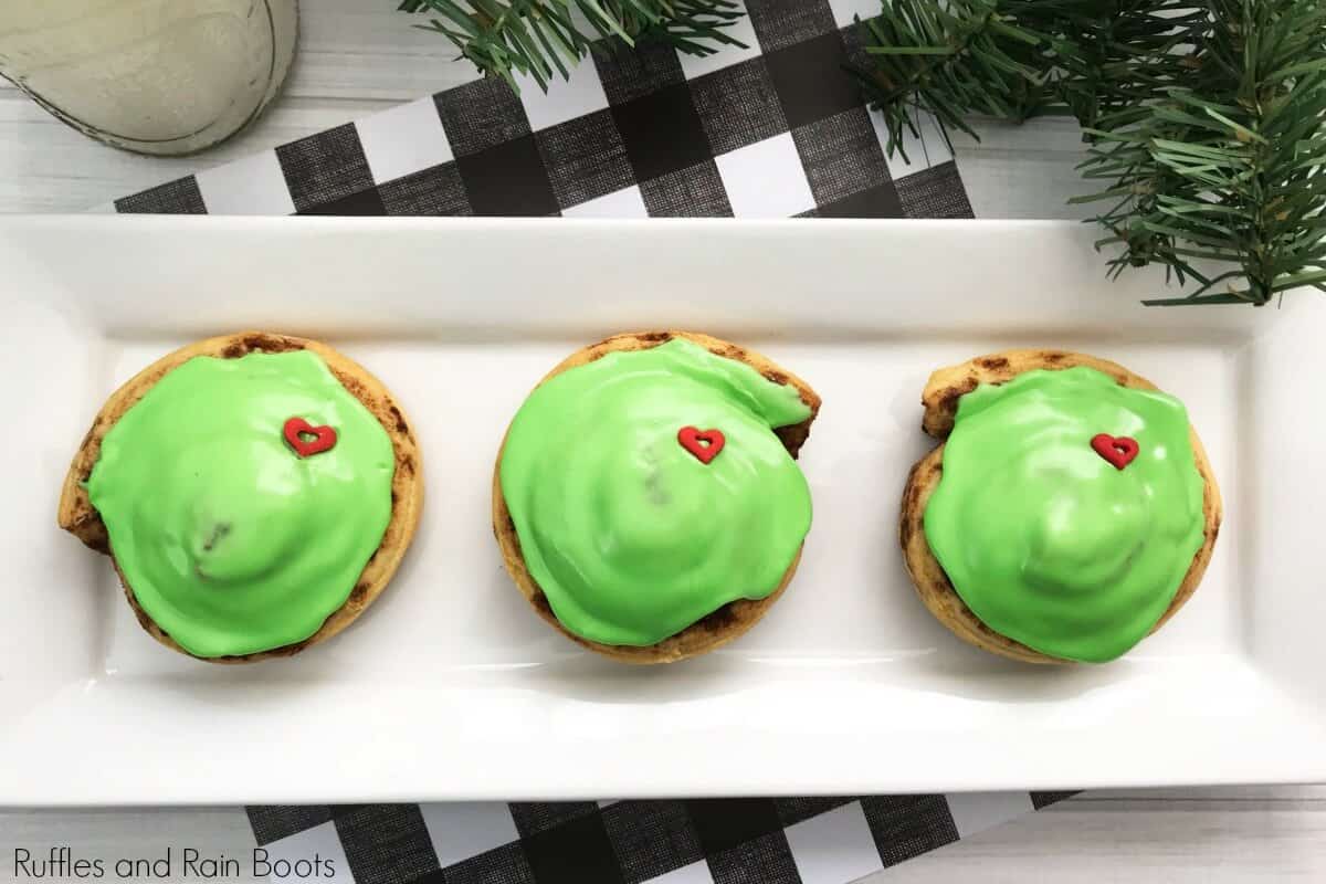 Grinch cinnamon rolls recipe for holiday breakfast on white plate with black and white background