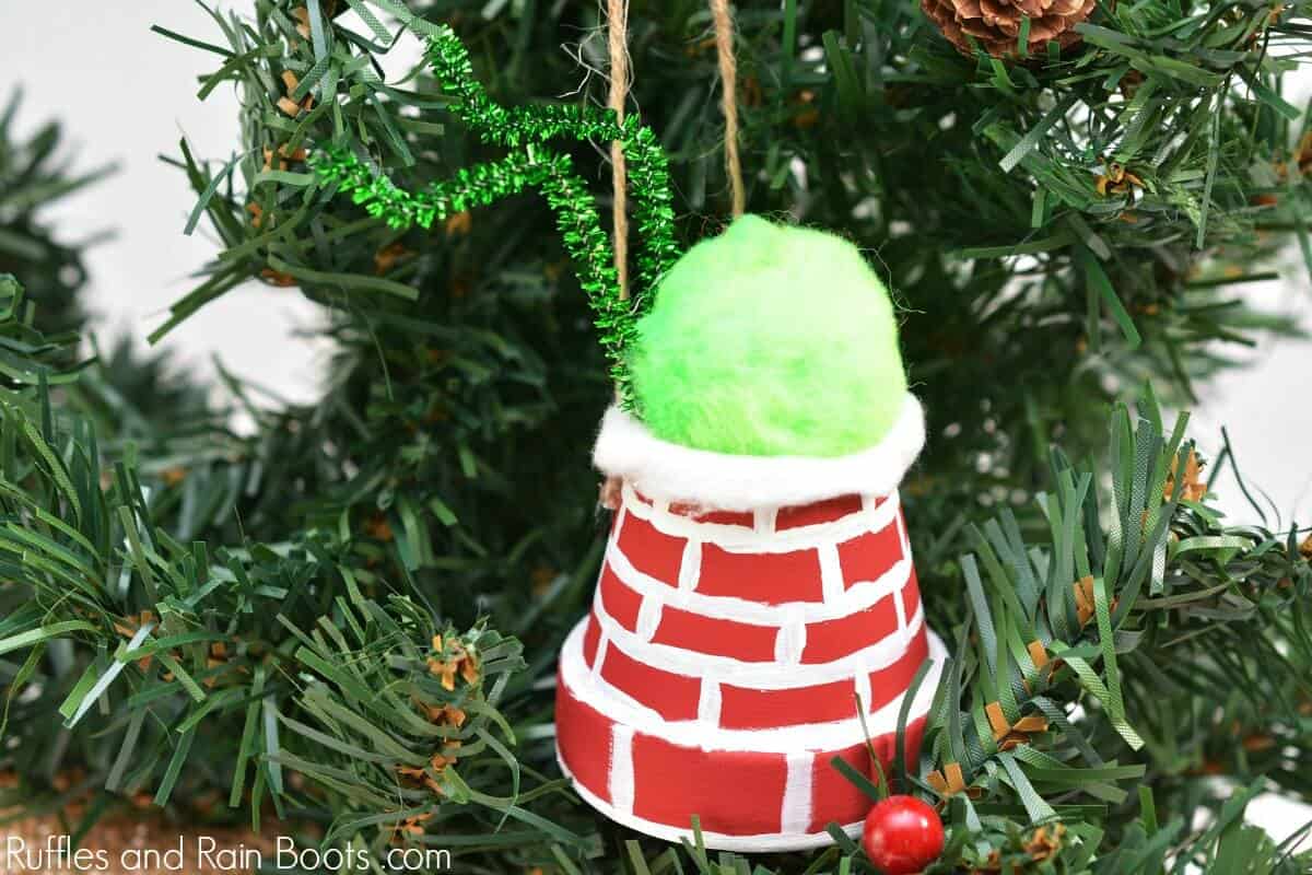 DIY Grinch ornament on Christmas tree background
