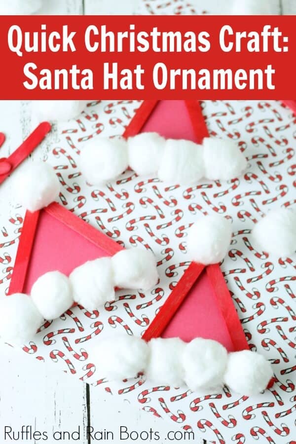 adorable Christmas Santa Hat Craft Stick ornament on holiday background with text which reads quick Christmas craft Santa hat ornament