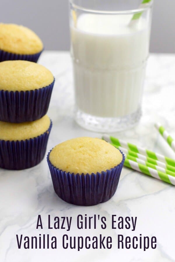 Vertical image close up of vanilla cupcakes in blue liner on marble background with text which reads A Lazy Girl's Easy Vanilla Cupcake Recipe.