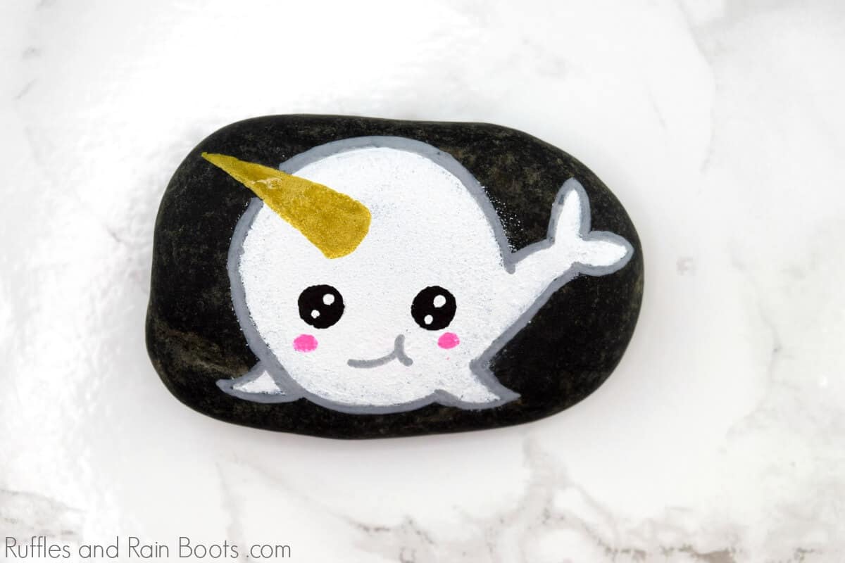 white narwhal rock painting idea on white marble background