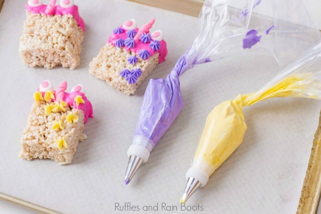icing bags with pink and yellow colors showing how to add flowers to the unicorn rice krispies