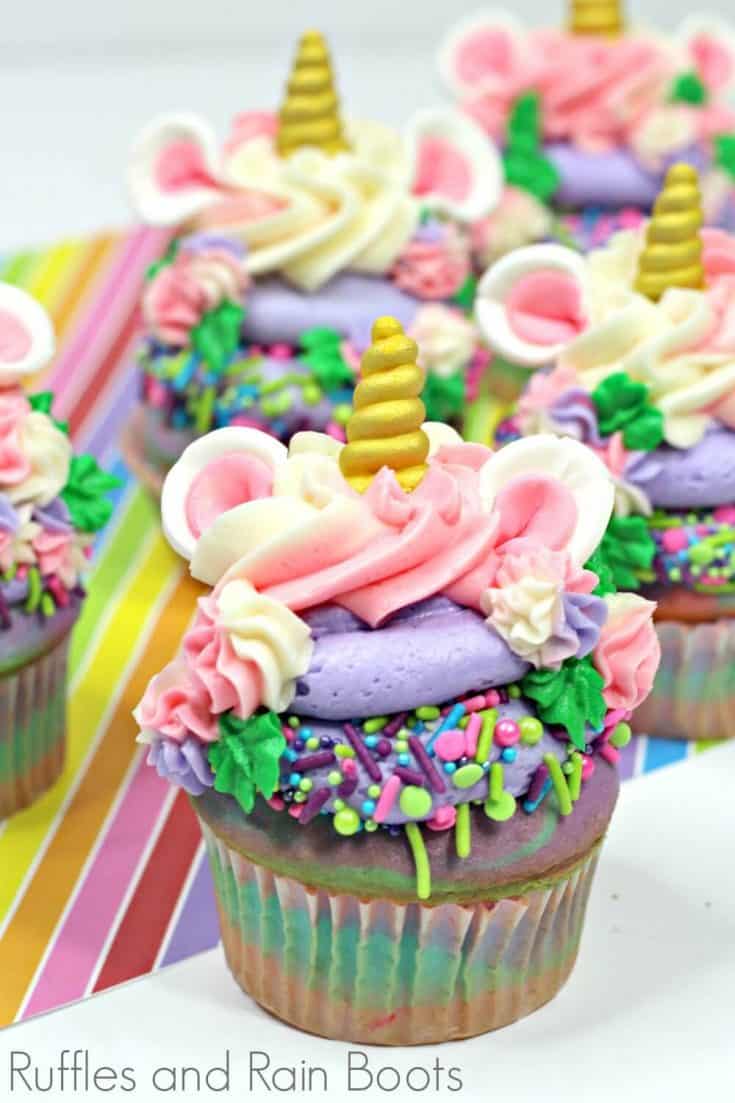 close up of colorful unicorn cupcakes recipe on rainbow background