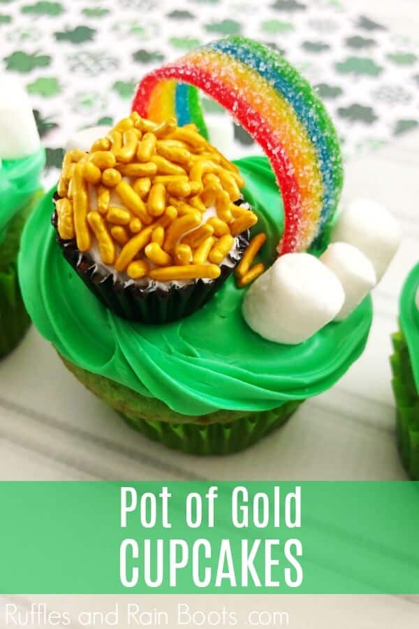 vertical image of rainbow with marshmallow clouds and a rainbow candy as a Saint Patrick's day cupcake idea with text which reads pot of gold cupcakes 