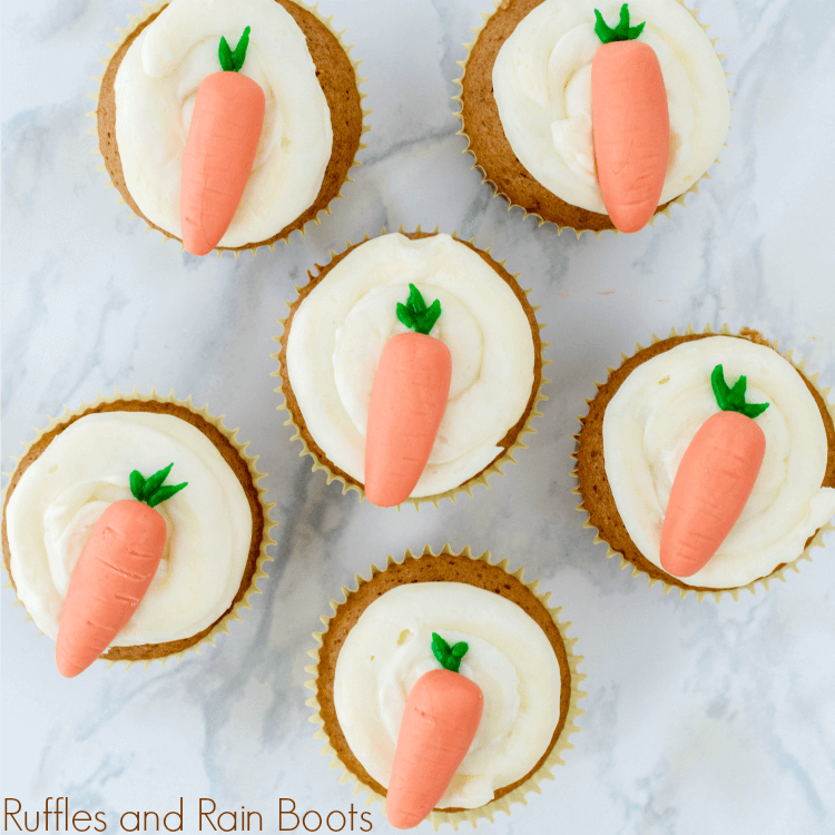 close up of six carrot cupcakes for Easter on white counter