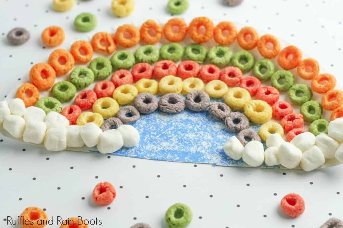 rainbow cereal paper plate craft for kids on white and black polka dot background