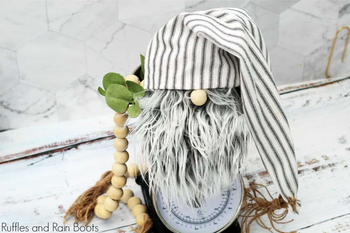 close up of farmhouse gnome on kitchen scale on white background