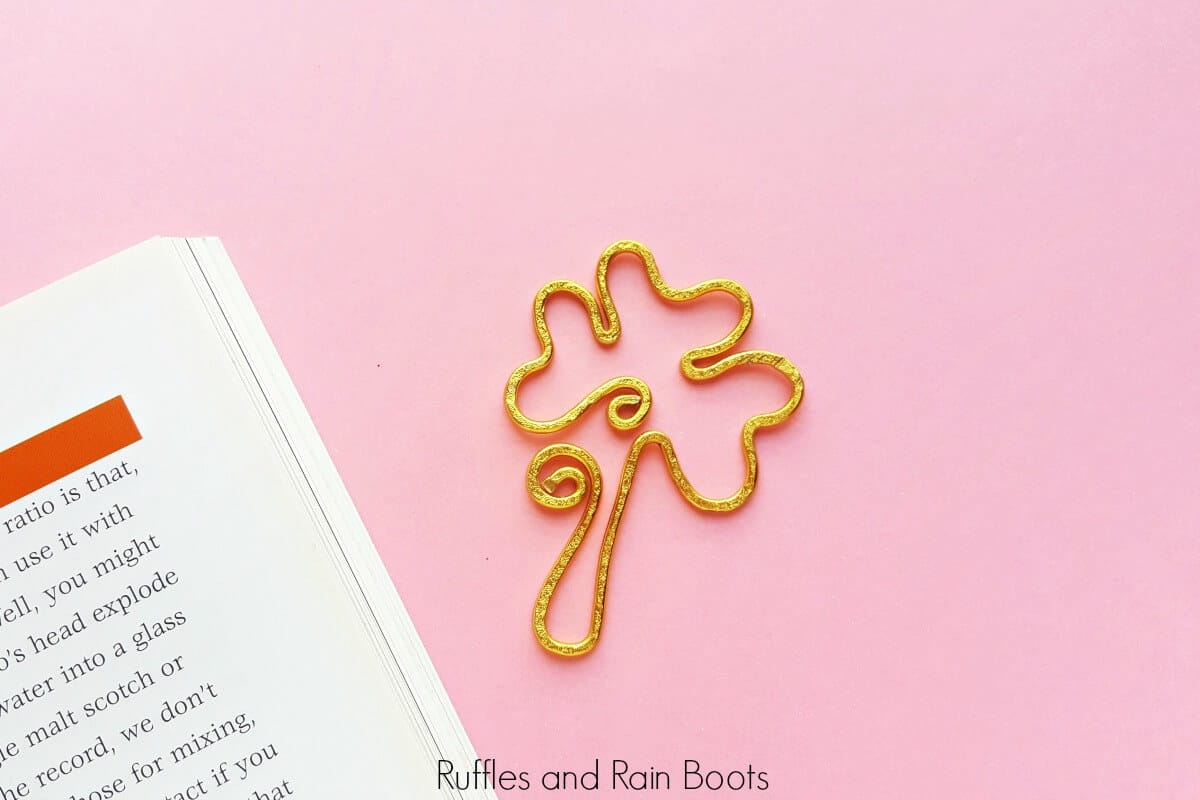 adorable shamrock bookmark in wire on pink background