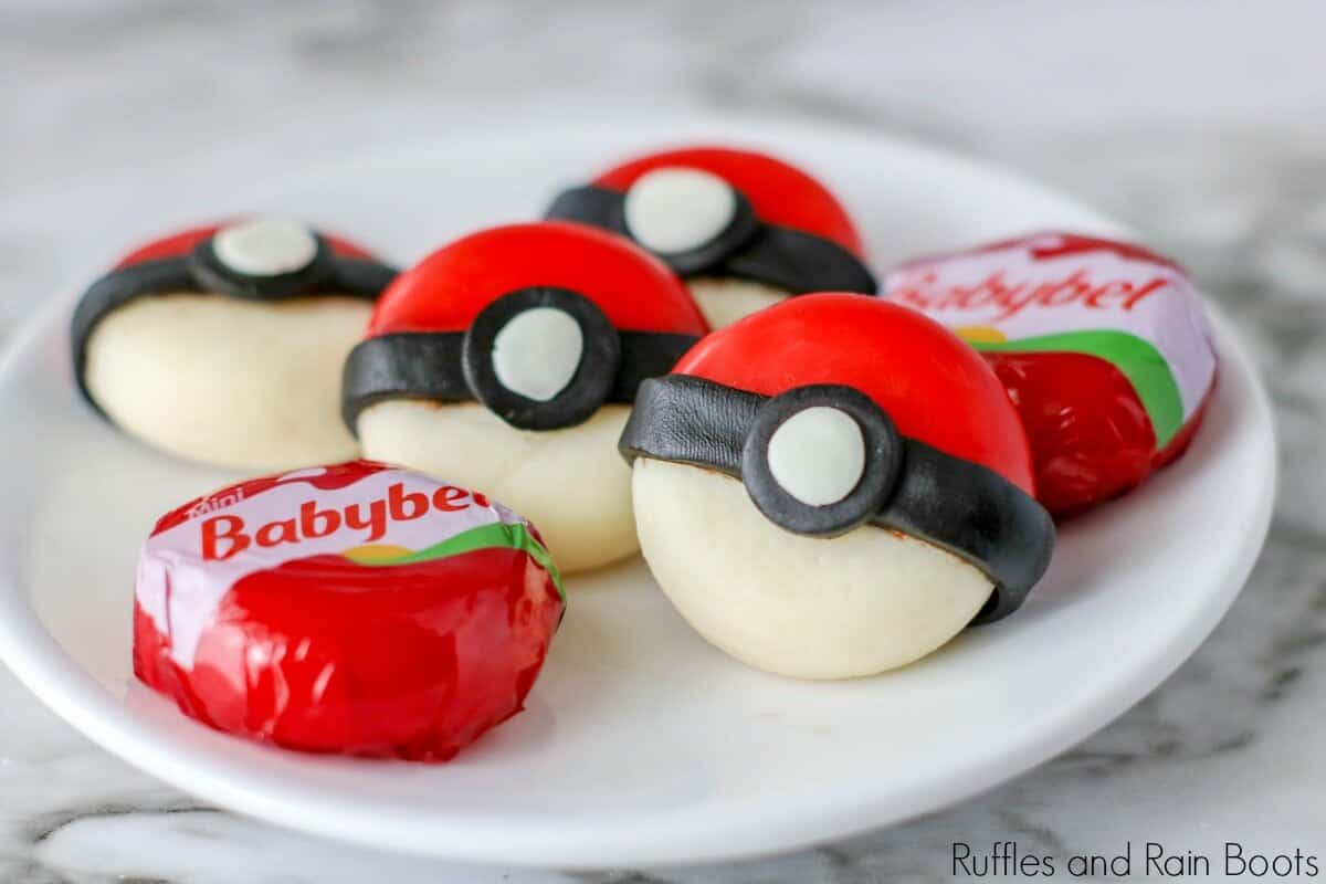 cheese shaped like pokeball cheese snack on a white plate