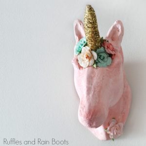 close up of unicorn head on white wall