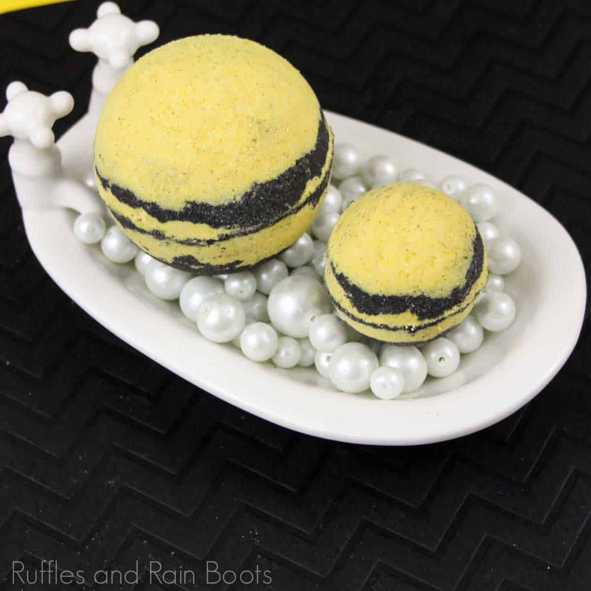 hufflepuff bath bombs in a tiny toy bathtub on a black background