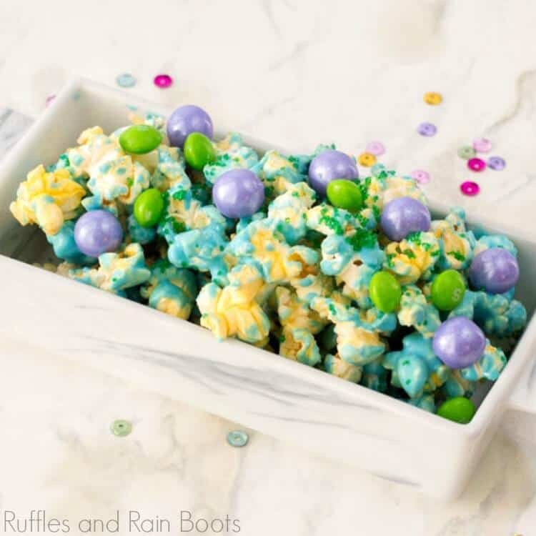 Close up of mermaid popcorn in a white bowl on a white background.