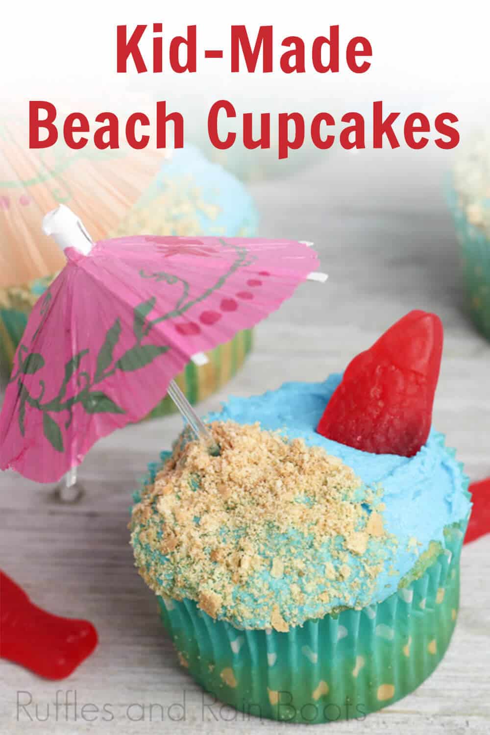 close-up of single beach cupcakes for kids to make on a light beige background with scattered red candy fish with text which reads kid-made beach cupcakes
