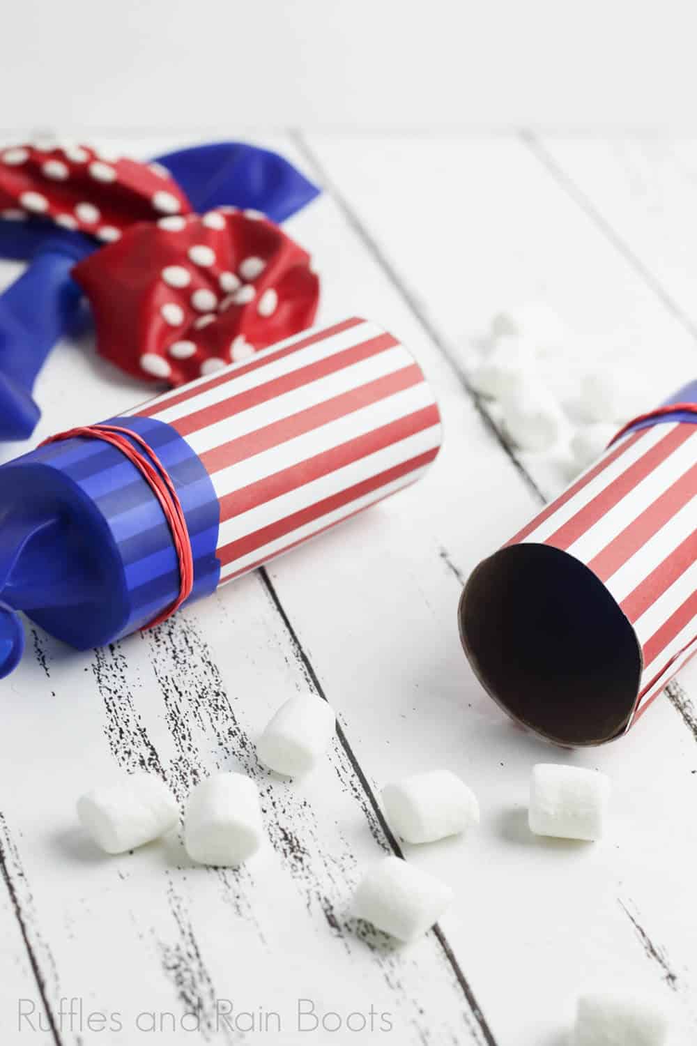 two marshmallow launchers on a wooden board as independence day party ideas for kids