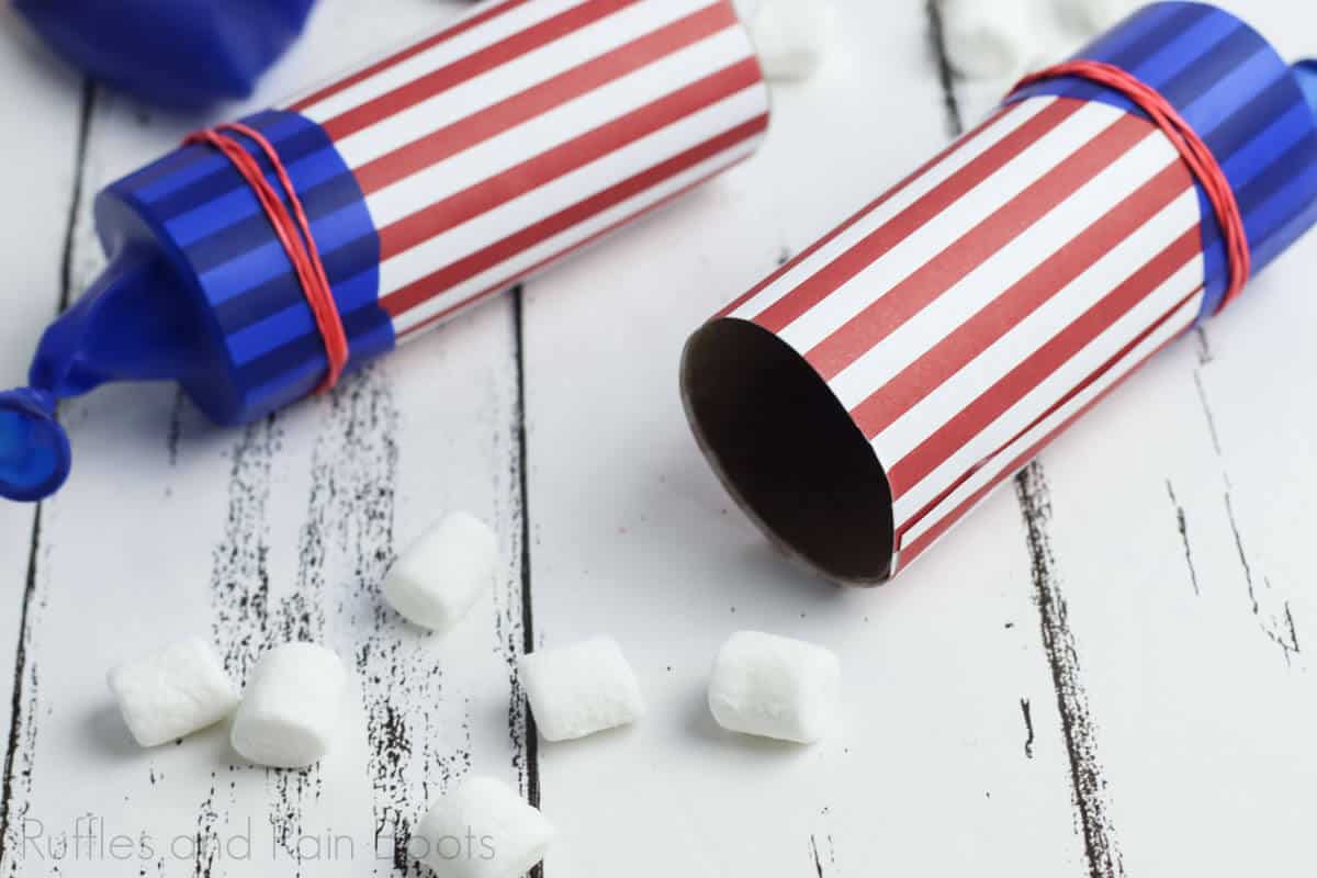 two marshmallow shooters launchers for the 4th of july on a wooden board