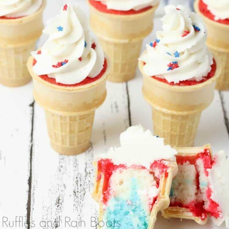 surprise patriotic ice cream cone cupcakes for 4th of july cut in half and laying on a wooden table with two additional ice cream cone cupcakes in the background