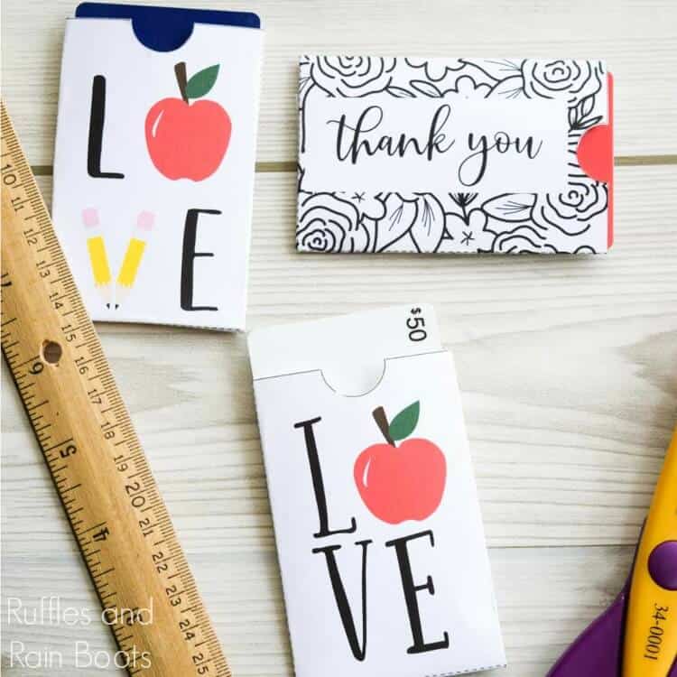 close up of teacher appreciation gift card sleeves on wood background