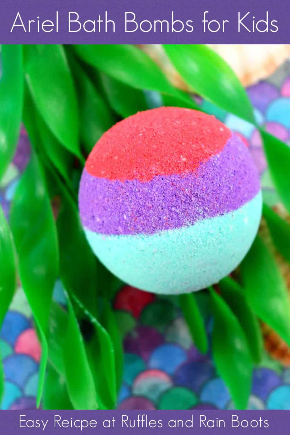 single red purple and teal bath bombs for kids ariel the little mermaid on fake sea grass with a shell sitting on a brightly colored scale-design table