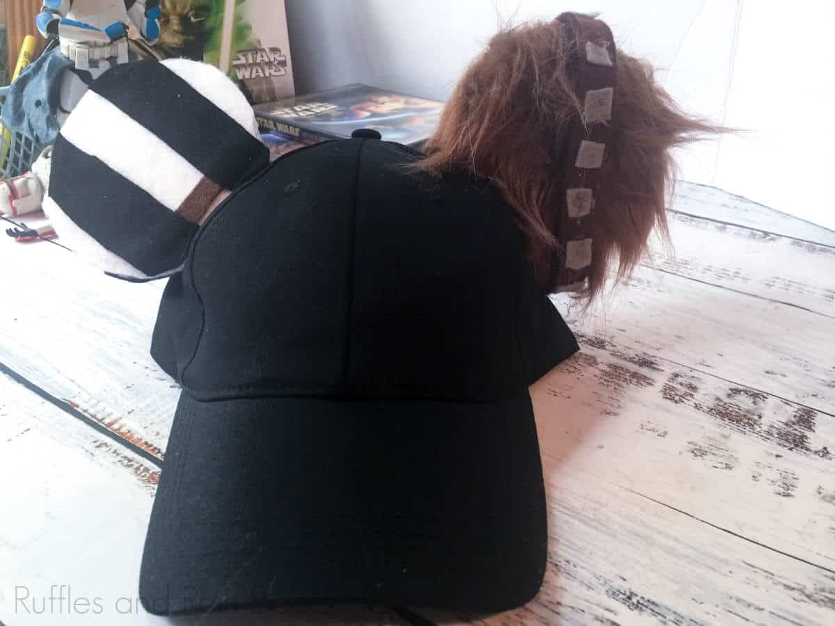 hand and chewbacca mickey ear hat on a white table