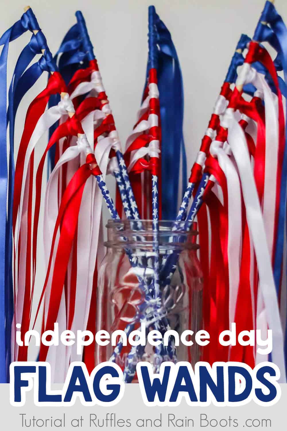 independence day flag wands with ribbon in a mason jar on a white background with text which reads independence day flag wands