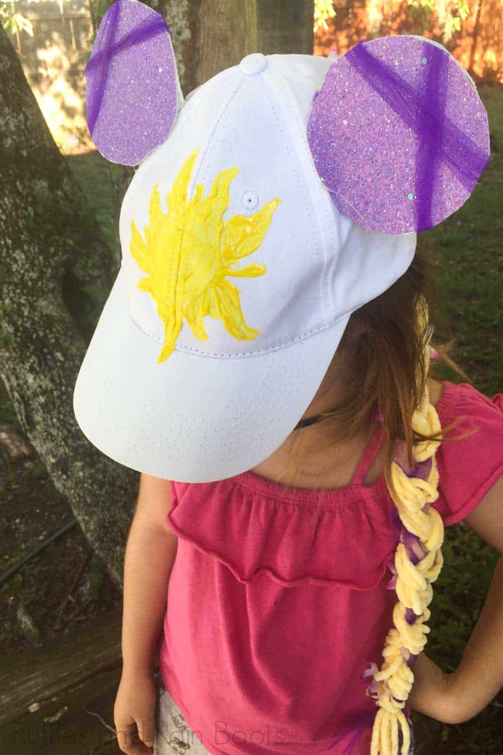 kid made rapunzel minnie ears on a child in a pink shirt