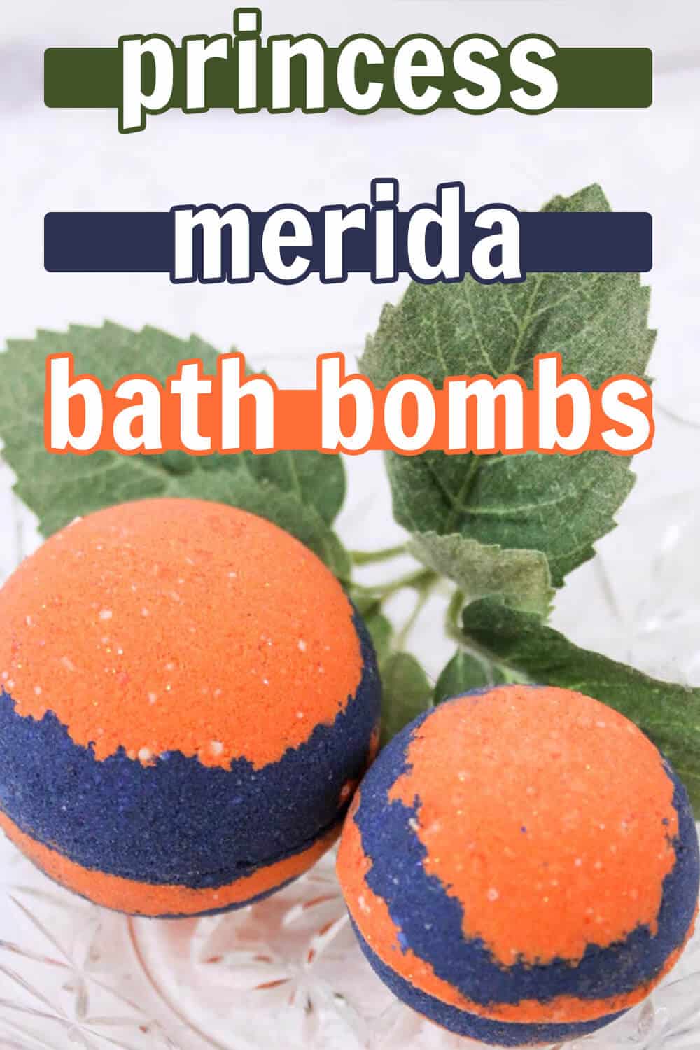 two orange and blue bath bombs on a white table with green leaves in the background with text which reads princess merida bath bombs