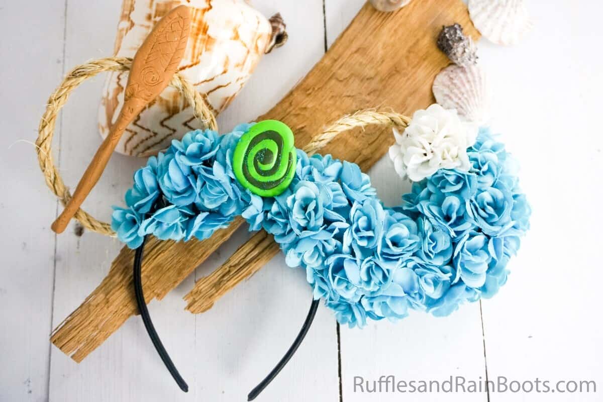 easy diy moana mickey ears for disney on a white wood background with driftwood and shells