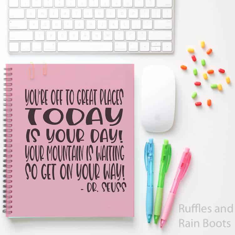 Dr. Seuss Quote back to school svg file on Notebook with pens a mouse keyboard and pushpins on a white table