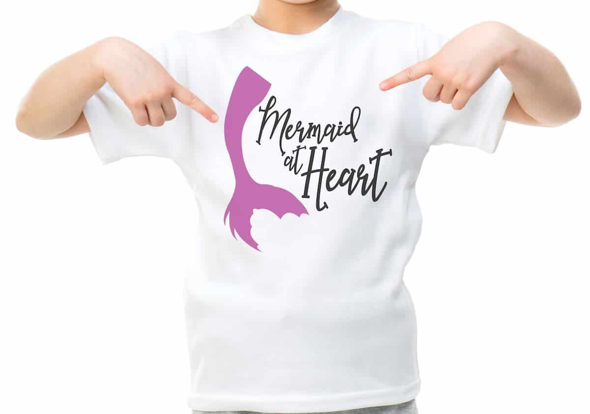 free mermaid at heart mermaid svg file for cricut on a kid's shirt on a white background