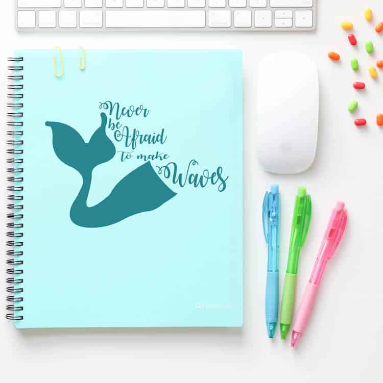 never be afraid to make waves free downloadable cut file on a blue notebook with other items on a white desk