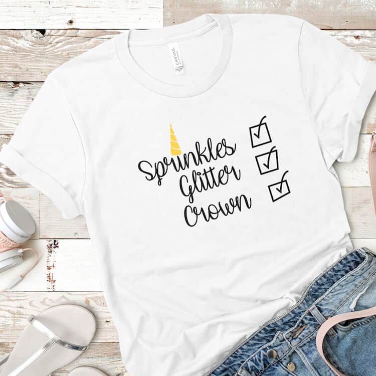 Sprinkles Glitter Crown free unicorn cut files for Silhouette on white t-shirt with jean shorts and headphones on a beige wood background