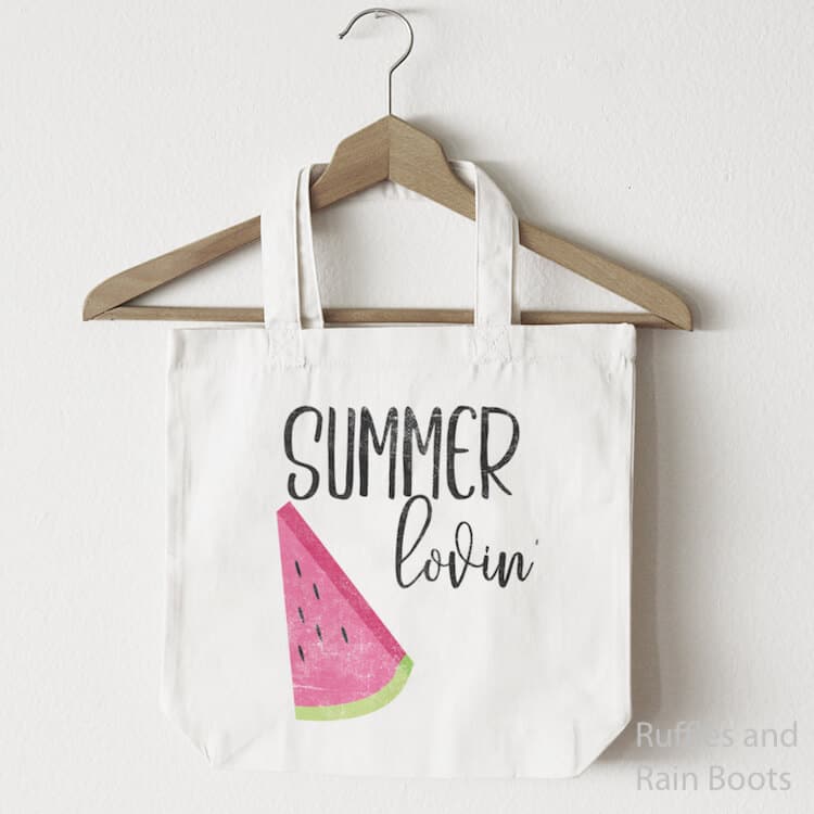 Summer Lovin' free summer cut file for SIlhouette with Watermelon Slice on a canvas bag hanging from a wooden clothes hanger on a white background