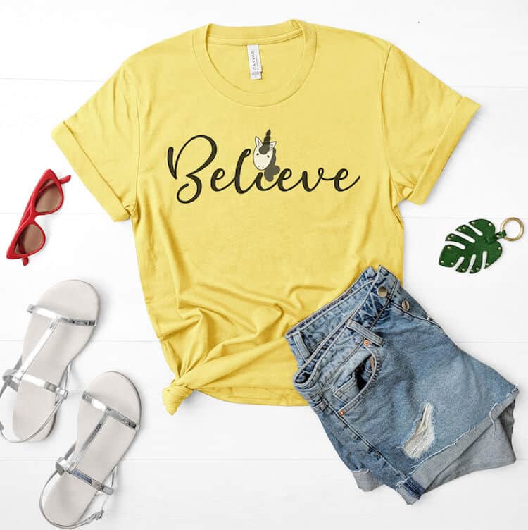 Believe free unicorn svg on yellow t-shirt with jean shorts, sandals and sunglasses on white background