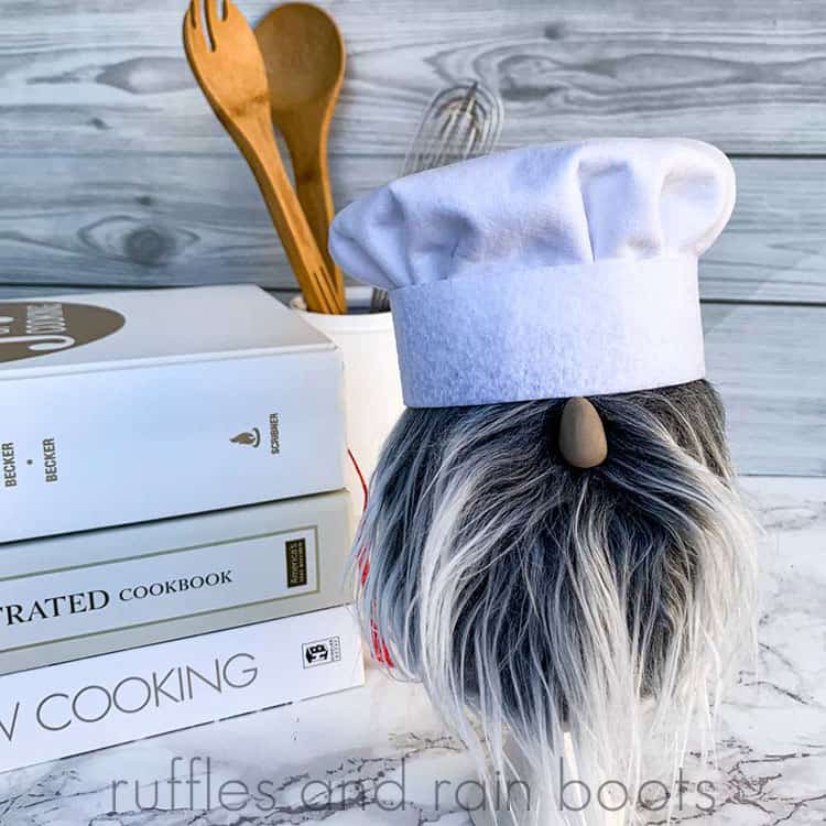 close up of chef gnome in front of cookbooks and kitchen utensils