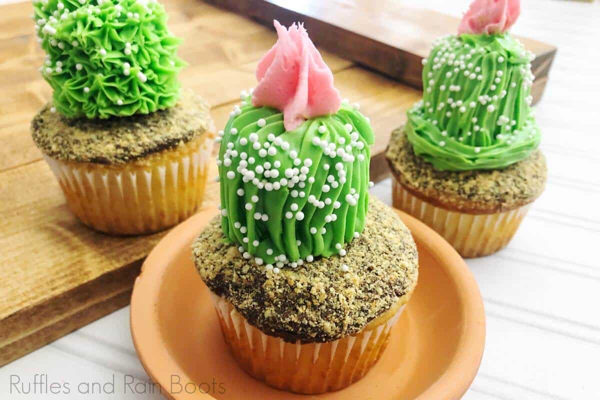 three Easy and Adorable Cactus Cupcakes for Party on a white wood background