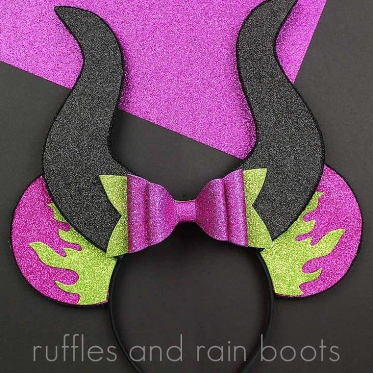 purple and green foam Maleficent ears on black and purple background