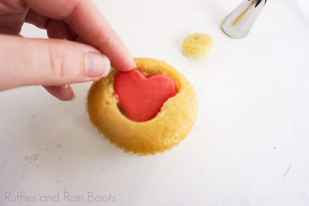 step 5 how to make grinch cupcakes put a candy heart inside the cupcake