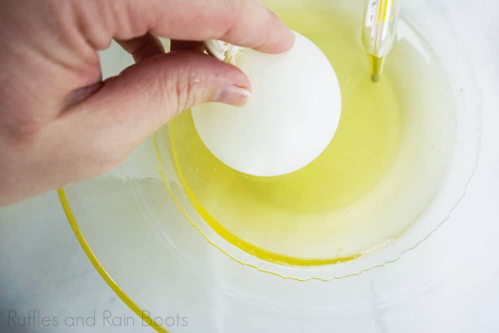 step 5 how to make sugar glass snow globe cupcakes dip balloons in sugar mixture
