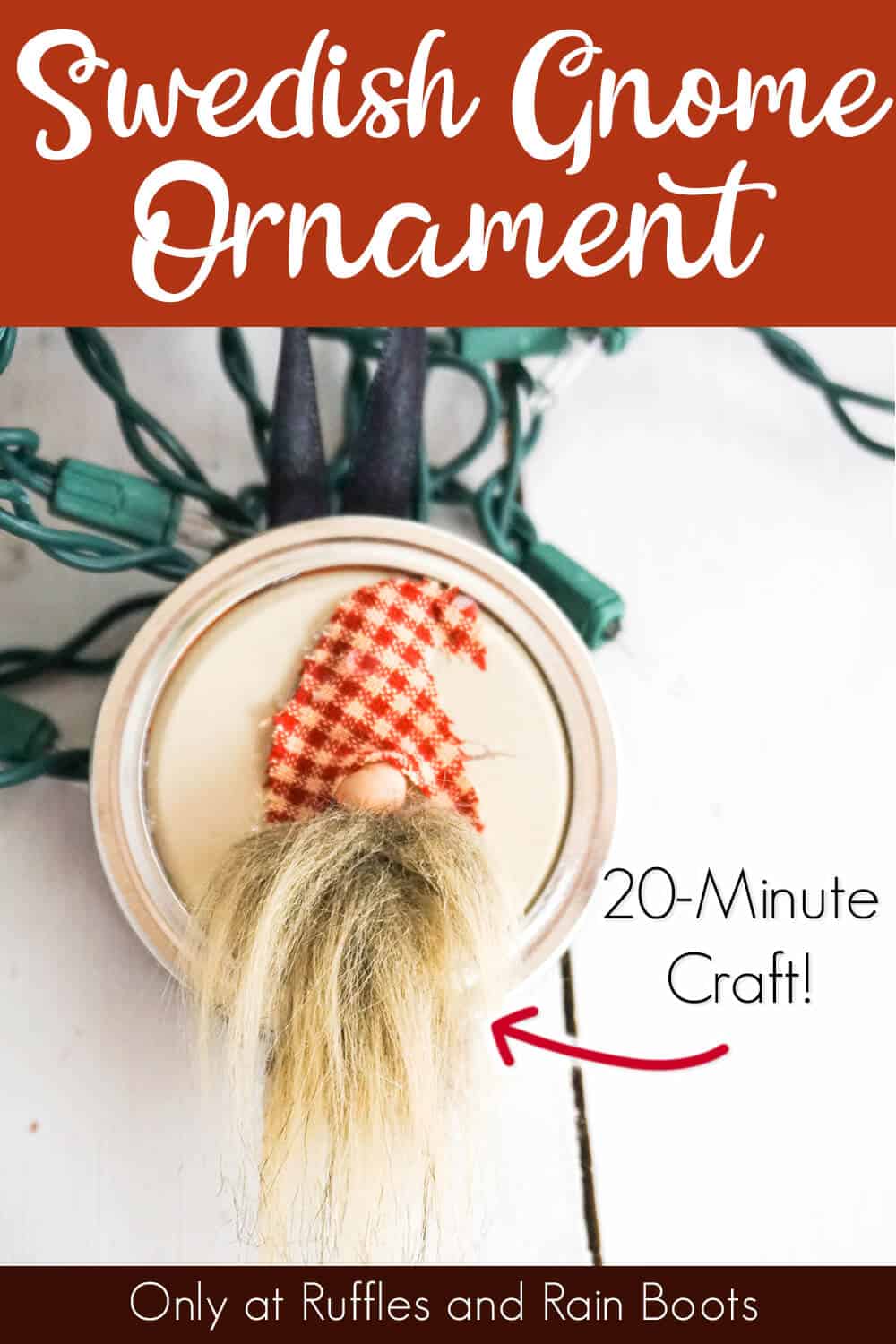 easy ornament made from a mason jar lid with a gnome face on it on a white table with christmas lights with text which reads swedish gnome ornament 20-minute craft