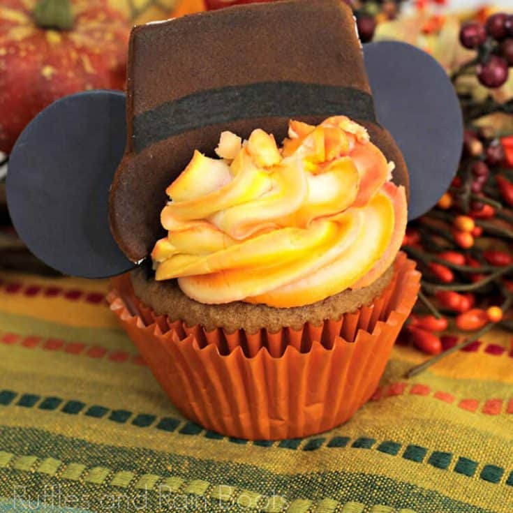 square close up image of adorable Thanksgiving Mickey ear cupcake with a spiced cake and ombre frosting technique on fall background