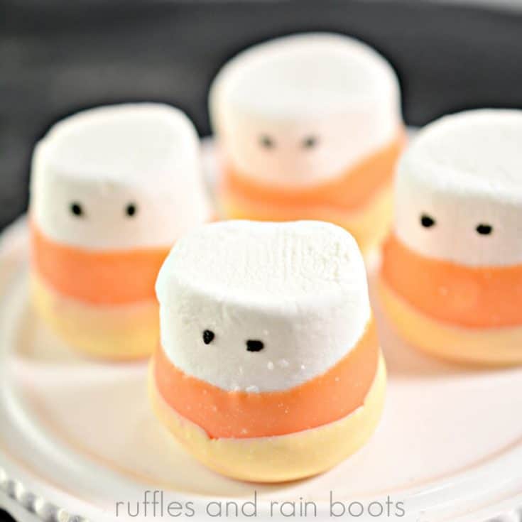 cute candy corn dipped marshmallows on a cupcake platter