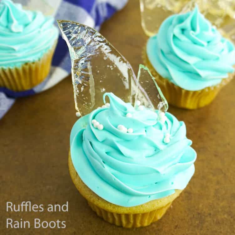 overhead view of how to make frozen cupcakes for a frozen party on a wood background